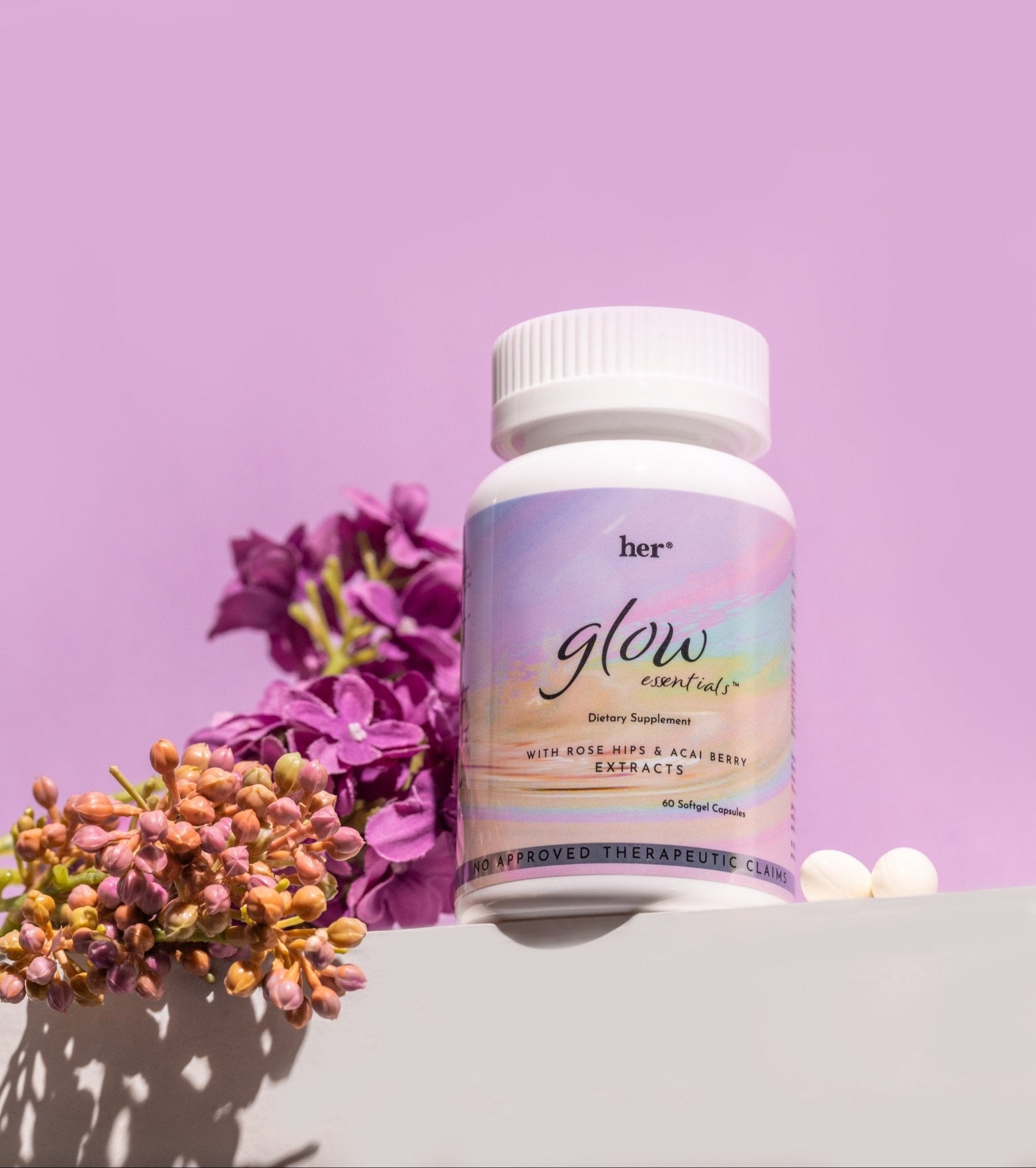 HER® Glow Essentials® capsule resting on a surface, with a detailed focus on the high-quality, traceable marine collagen and other active ingredients it contains.