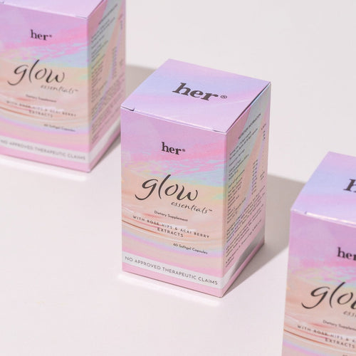 The HER® Glow Essentials® box  artfully arranged for a holistic self-care routine.